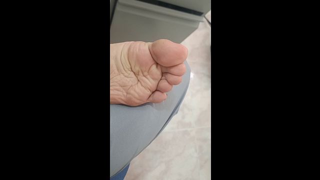 My girlfriend reveals her sexy feet while working.